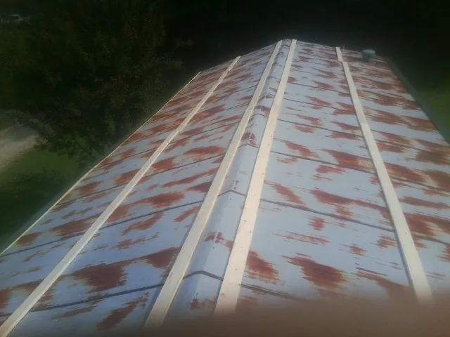 Rusted metal roof panels with new wood purlins before replacement — Storm Damage Roof Repair in Indiahoma by Roofing Brothers