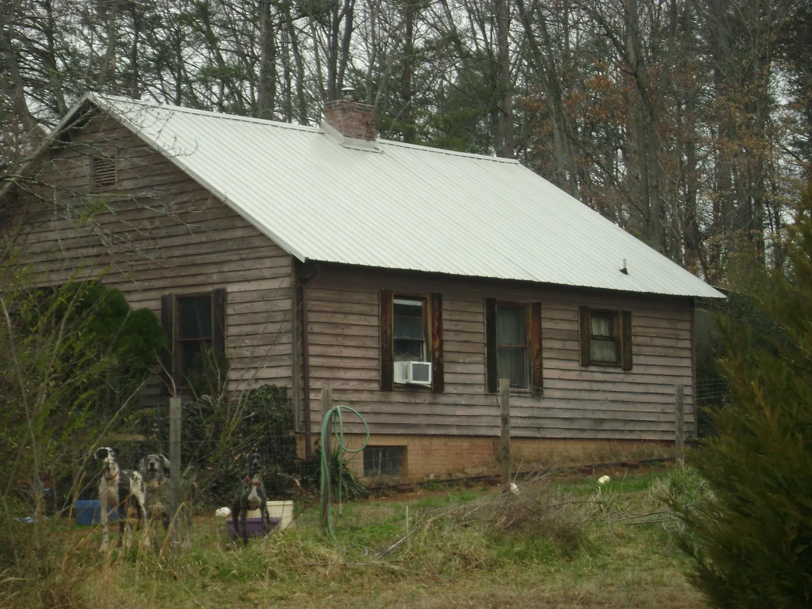 White metal roof on an old wood sided farmhouse, from a Metal Roof Installation job in Indiahoma